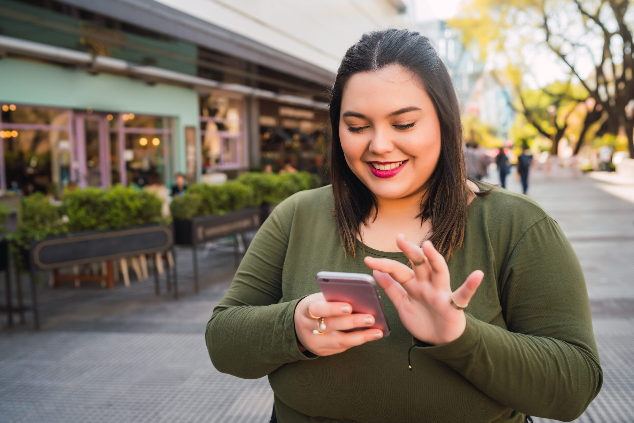 Young Plus Size Woman Using Her Mobile Phone.