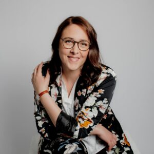 A Woman Wearing Eyeglasses And Floral Long Sleeves