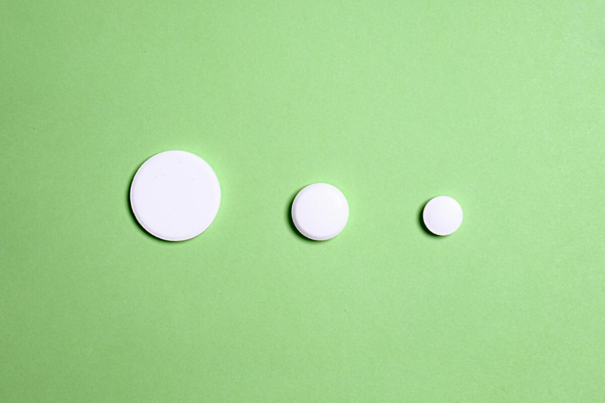 White Round Medication Pill On Green Surface